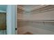 Walk-in closet featuring white shelving and wood-style tile flooring at 791 Saint Judes Dr N, Longboat Key, FL 34228