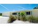 Charming single-story home featuring manicured landscaping and ample natural light at 791 Saint Judes Dr N, Longboat Key, FL 34228