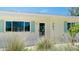 Welcoming facade with neat landscaping, complemented by the house number at 791 Saint Judes Dr N, Longboat Key, FL 34228