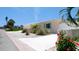 Charming home features a freshly painted elevation, well-maintained landscaping, and a white stone driveway at 791 Saint Judes Dr N, Longboat Key, FL 34228