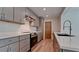 Modern kitchen with gray cabinets, stainless steel appliances, and white quartz countertops at 791 Saint Judes Dr N, Longboat Key, FL 34228