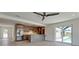 Open living space with gray cabinets, stainless steel refrigerator, and sliding door to the pool at 791 Saint Judes Dr N, Longboat Key, FL 34228