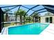 Waterfront view of screened pool with lush tropical landscaping at 791 Saint Judes Dr N, Longboat Key, FL 34228