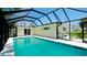 Screened-in pool offers a private backyard retreat with a covered seating area and lush tropical landscaping at 791 Saint Judes Dr N, Longboat Key, FL 34228
