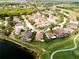 Aerial view of a home's location within a golf course community near a serene lake at 834 Springwood Cir, Bradenton, FL 34212