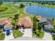 A stunning aerial view of the residence overlooking the golf course and nearby lake, with lush landscaping at 834 Springwood Cir, Bradenton, FL 34212