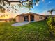 Landscaped backyard with an enclosed lanai offers beautiful sunset views over the water at 834 Springwood Cir, Bradenton, FL 34212