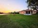 Lush backyard with lake view, fruit trees, and screened-in patio. Ideal for outdoor relaxation and entertaining at 834 Springwood Cir, Bradenton, FL 34212
