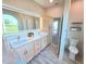 Bright bathroom with double sinks, quartz countertops, and modern wood-look flooring at 834 Springwood Cir, Bradenton, FL 34212