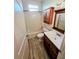 Bathroom features a shower-tub combo with wood look flooring and a single vanity at 834 Springwood Cir, Bradenton, FL 34212