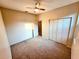 Neutral bedroom featuring carpet, ceiling fan, a closet and view to the ensuite bathroom at 834 Springwood Cir, Bradenton, FL 34212