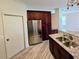 Kitchen showcasing stainless steel refrigerator, granite countertops, sink, and matching dark wood cabinets at 834 Springwood Cir, Bradenton, FL 34212