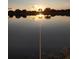 Stunning lake view at sunset, capturing the sun's reflection on the calm water at 834 Springwood Cir, Bradenton, FL 34212