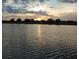 Peaceful lake view reflecting the sunset with cloudy skies above the horizon at 834 Springwood Cir, Bradenton, FL 34212