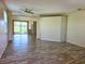 Spacious living room with modern flooring, ceiling fan, and expansive views of the lake and golf course at 834 Springwood Cir, Bradenton, FL 34212