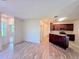 Open-concept living area featuring modern flooring, leading into the kitchen area with island seating at 834 Springwood Cir, Bradenton, FL 34212