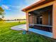 View of screened-in patio overlooking a lush lawn and serene lake at 834 Springwood Cir, Bradenton, FL 34212