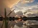 Picturesque pond view with beautiful reflections of the sunset and dramatic clouds at 834 Springwood Cir, Bradenton, FL 34212