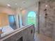 Stylish bathroom with glass-enclosed shower, modern fixtures, and adjacent double sink vanity at 834 Springwood Cir, Bradenton, FL 34212