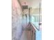Modern shower featuring marble walls, hexagon tile floor and glass partition at 834 Springwood Cir, Bradenton, FL 34212