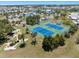 Aerial view showcasing tennis courts, a mini-golf course, and lush green landscaping at 842 Jolanda Cir, Venice, FL 34285