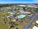 Aerial shot highlighting the community pool, shuffleboard, and tennis courts at 842 Jolanda Cir, Venice, FL 34285