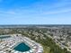 Aerial view of the neighborhood showcasing the community layout with lakes and residential homes with the ocean in the background at 842 Jolanda Cir, Venice, FL 34285