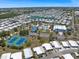 Aerial view showcasing the vibrant community with a pool, tennis courts, and lake at 842 Jolanda Cir, Venice, FL 34285