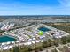 Aerial view of manufactured home community with scenic water features and distant ocean views at 842 Jolanda Cir, Venice, FL 34285