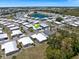 Beautiful aerial view of the neighborhood and manufactured homes with a gorgeous lake nearby at 842 Jolanda Cir, Venice, FL 34285