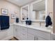 Elegant bathroom featuring double vanity, with white cabinetry and nautical themed decorations and decor at 842 Jolanda Cir, Venice, FL 34285