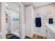 Beautiful bathroom featuring tiled shower, matching white vanity and nautical themed decor and decorations at 842 Jolanda Cir, Venice, FL 34285