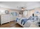 Inviting bedroom with white furnishings, ceiling fan and sliding barn door leading to an ensuite bath at 842 Jolanda Cir, Venice, FL 34285