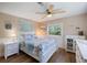 Comfortable bedroom featuring ceiling fan, wood floors, and views of the backyard at 842 Jolanda Cir, Venice, FL 34285