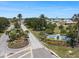 Street view of the community entrance sign surrounded by lush landscaping and mature palm trees at 842 Jolanda Cir, Venice, FL 34285
