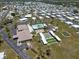 Panoramic aerial view of the community featuring the pool, clubhouse, and numerous manufactured homes at 842 Jolanda Cir, Venice, FL 34285