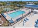 Aerial view of a community pool area with ample seating, a hot tub, and beautifully maintained grounds at 842 Jolanda Cir, Venice, FL 34285