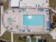 Bird's eye view of the community pool, hot tub, shuffleboard court and lounge chairs under the bright sun at 842 Jolanda Cir, Venice, FL 34285