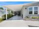 Spacious carport attached to a charming single-story home with a light-blue exterior and landscaped flower beds at 842 Jolanda Cir, Venice, FL 34285