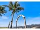 A beautiful view of the Venice Fishing Pier entrance with a palm tree and blue sky at 842 Jolanda Cir, Venice, FL 34285