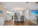 Modern kitchen boasts white cabinets, stainless steel appliances, and a center island with bar seating at 842 Jolanda Cir, Venice, FL 34285