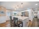 Modern kitchen with white cabinets, stainless steel appliances, a center island, and wood-look floors at 842 Jolanda Cir, Venice, FL 34285