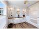 Bright living room with built-in shelving and cabinets, featuring shiplap accents and wood flooring at 842 Jolanda Cir, Venice, FL 34285