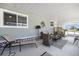 Inviting screened-in porch with comfortable patio furniture, a great space for enjoying the outdoors, partially shaded at 842 Jolanda Cir, Venice, FL 34285