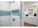 Modern bathroom with a tiled walk-in shower and open view into the double vanity area at 842 Jolanda Cir, Venice, FL 34285