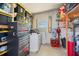 Tidy storage area features shelving units, tool chests, and a window, offering practical organization solutions at 842 Jolanda Cir, Venice, FL 34285