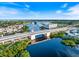 Aerial view of waterfront property with scenic bridge, landscaping and blue skies at 842 Jolanda Cir, Venice, FL 34285