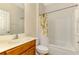 Bathroom boasts a vanity with cabinet, toilet, and shower with curtain at 9022 Coachman Dr, Venice, FL 34293
