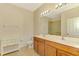Bathroom features double sinks with wood cabinets, mirror, and tile floors at 9022 Coachman Dr, Venice, FL 34293