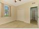 Comfortable bedroom features carpet floors, neutral walls, and a window with curtains at 9022 Coachman Dr, Venice, FL 34293